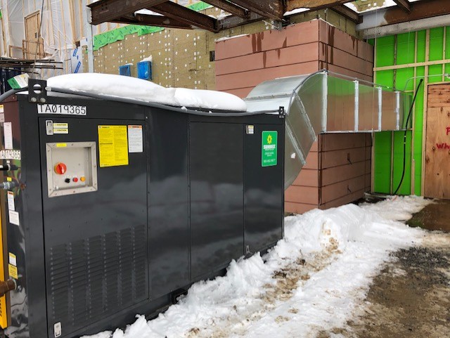 A commercial heater from Sunbelt Rentals, outside of a building.