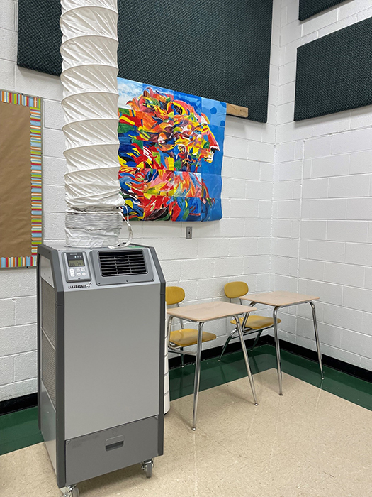 A portable heater installed in a classroom.