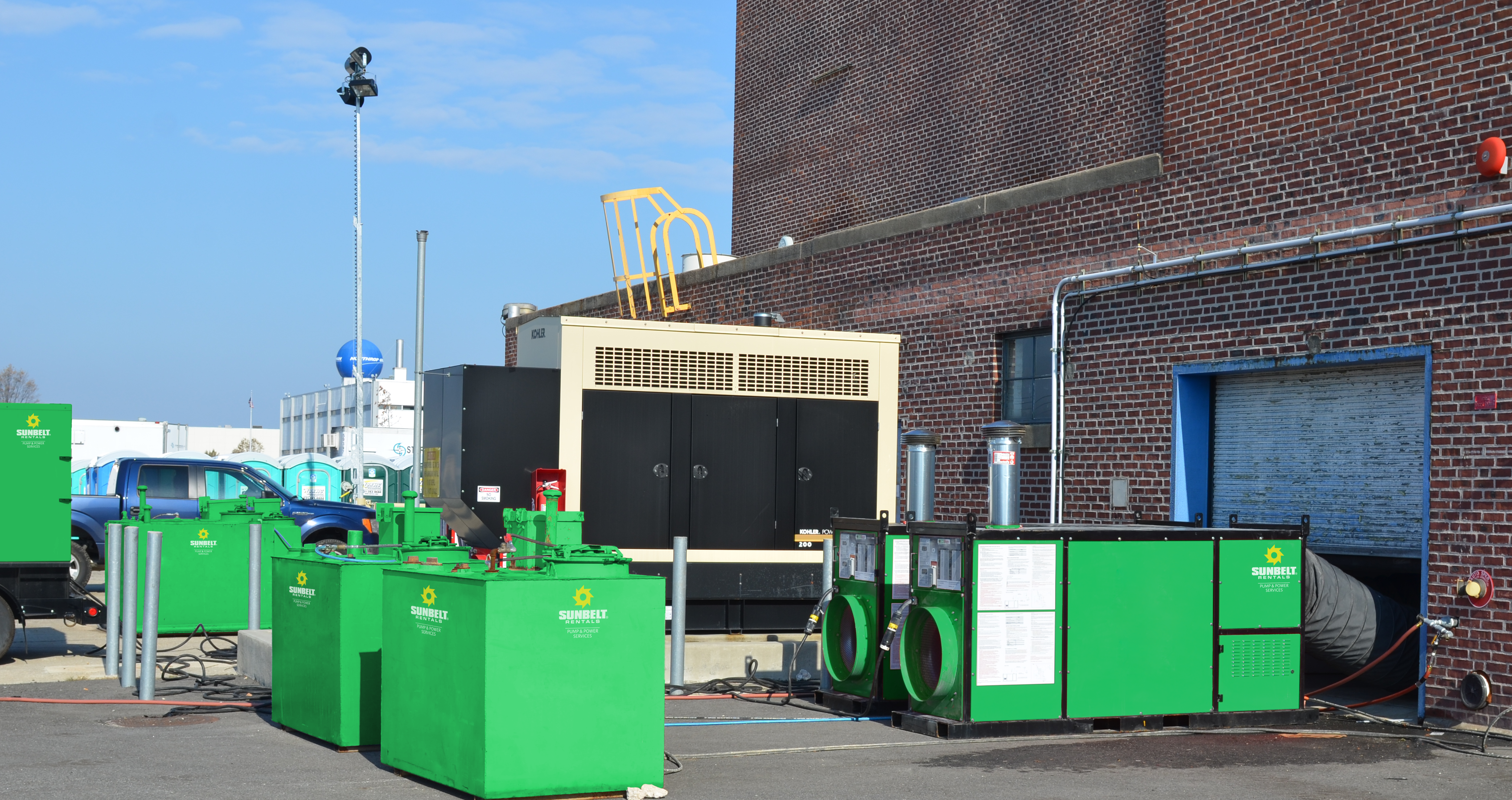 Supplemental heating sources from Sunbelt Rentals installed outside of a building.