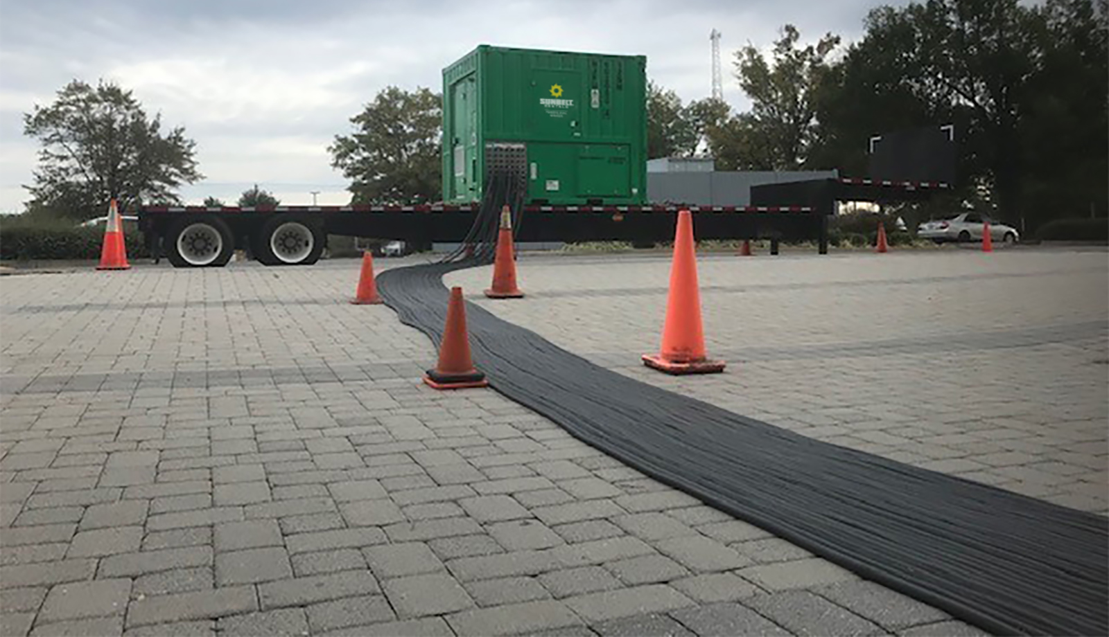 A load bank from Sunbelt Rentals installed in a parking lot marked with safety cones.