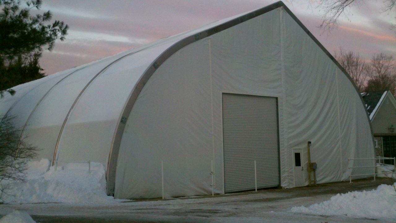 A tensile fabric structure installed in a snowy area.
