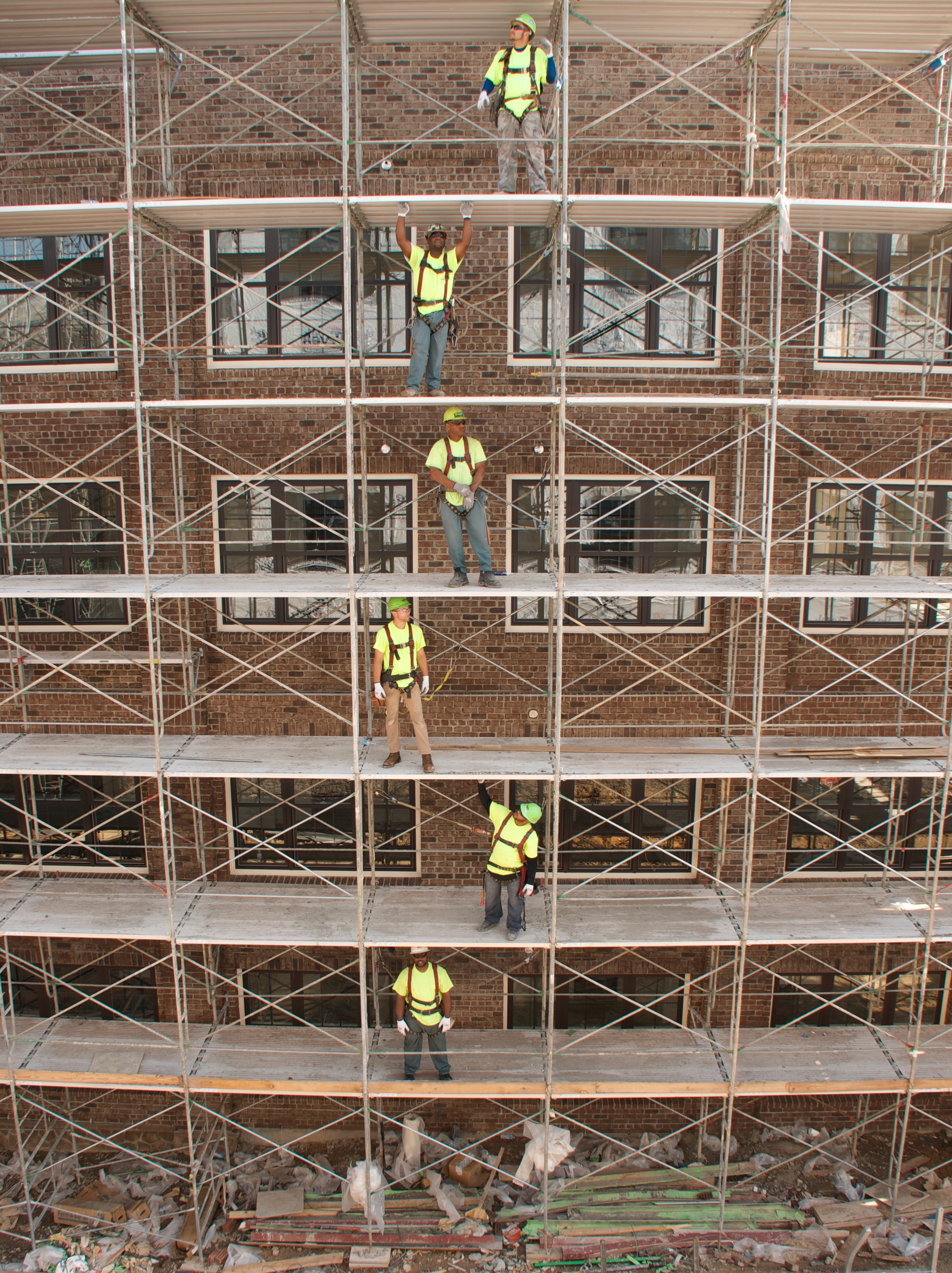 People working at a construction site with scaffolding.