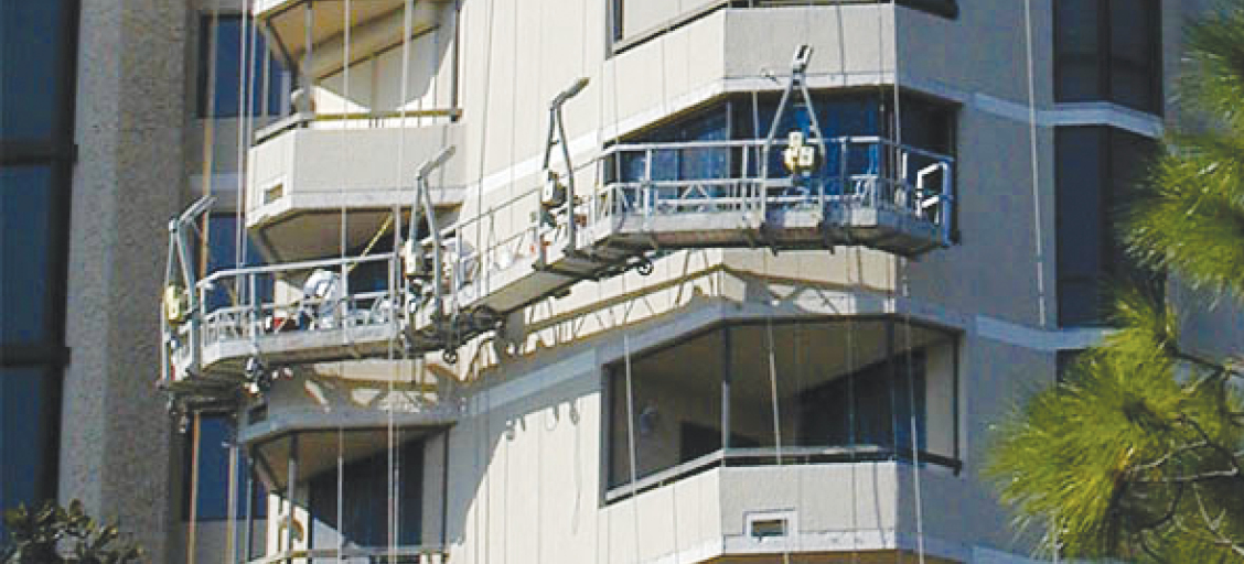 Scaffolding attached to the side of a high-rise building.